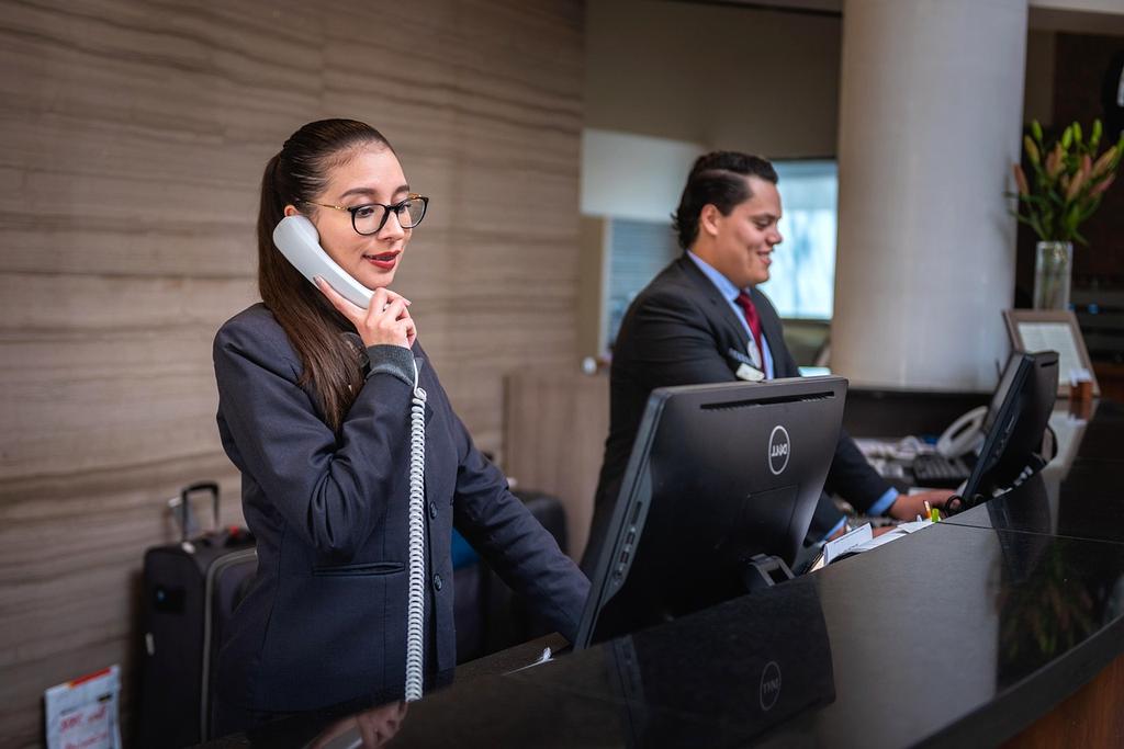 Customer service representative working at desk with headset